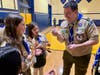 Energized trio of new Troop 19 Scouts receive the official Troop 19 uniform numerals from Scoutmaster Cannon