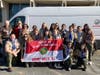Members of BSA Scout Troop 19 pose in front of Schindler Elevator fleet truck.