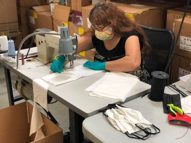 An Ernie Ball worker makes face masks that will eventually be given away to Coachella Valley residents.