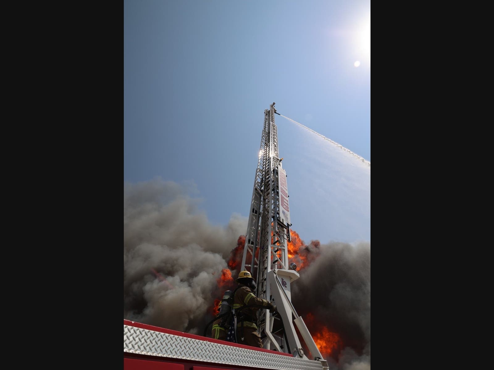 Cal Fire/Riverside County Fire Department battle the storage-yard fire in Perris.