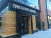 The three-story Punch Bowl Social restaurant has entrances on Wilson Boulevard and Ballston Quarter.