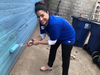 The Mission Continues volunteer Larissa Moran of San Antonio paints the courtyard wall outside Calvary Women’s Services' Anacostia home Thursday.