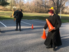 The Rev. Scott Holmer of St. Edward the Confessor Catholic Church places traffic cones in the parking lot of his church with the help of seminarian Colin Snyder.