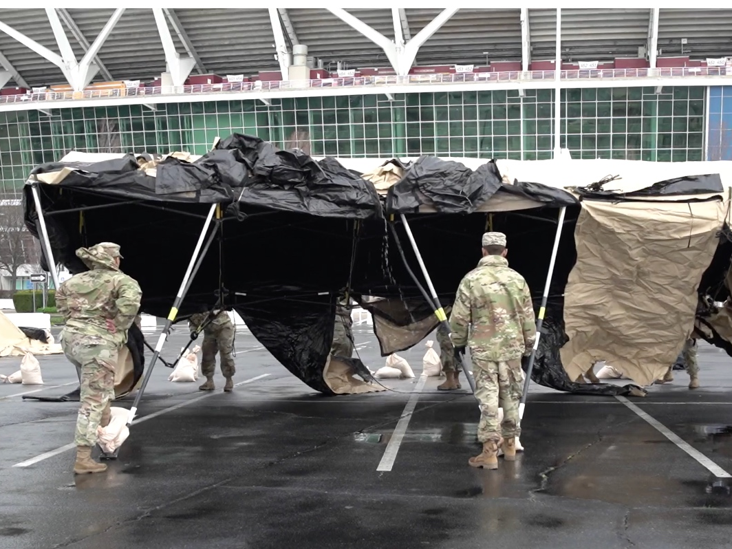 Members of the Maryland National Guard set up a tent for the coronavirus training facility at FedEx Field, which opens Monday.