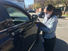 A volunteer takes information from an Arlington resident at Friday's coronavirus drop-off station.