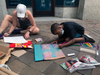 Marchers create their own signs while waiting at the U.S. Navy Memorial Plaza for the Black Mamas March to begin.