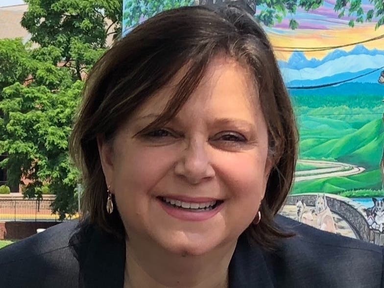 Signs Friedrichs, 58, is running for the Herndon Town Council.