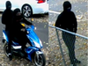 Surveillance video shows the suspects arriving on the scene and later fleeing aboard a moped.