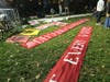 Protesters lay out banners on the grass at McPherson Square during Tuesday night's D.C. Watch Party.