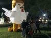 A group poses in front of the large inflatable chicken at McPherson Square during the Tuesday night D.C. Watch Party.