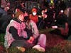 Two woman watch the election returns on the large TV screen at McPherson Square on Tuesday night.