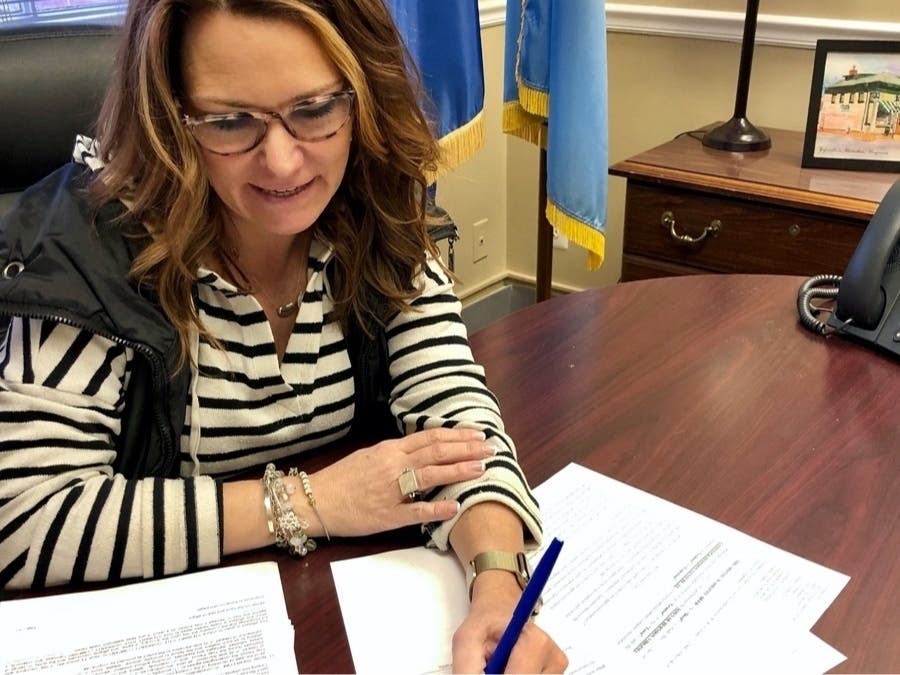 Herndon Mayor Lisa Merkel signs the agreement in her office at Herndon’s Town Hall.