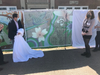 From left, IDI Managing Director Enrico Cecchi admires the mural on the arts created by Sarah Bird.