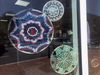 Crocheted lace doilies made by Steven Shumacher and Nita Armstrong decorate the windows of Make My Day CPA in Old Town Fairfax.