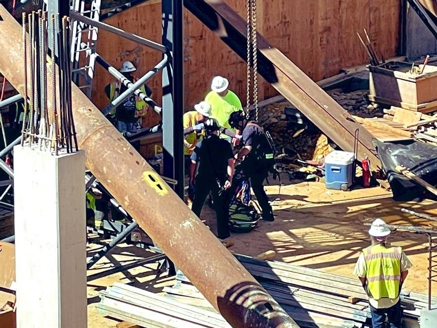 The Arlington County's Technical Rescue Team prepare to lift an injured worker out of a Ballston construction site Tuesday morning using an onsite crane. The worker was later taken to a nearby hospital to be treated for non-life threatening injuries.