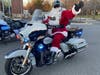 Santa waves as he prepares to stop outside the headquarters of the Fairfax City Police Department on Tuesday morning. A police motorcade will escort Santa across Fairfax County to pick up toys for children in need and at area hospitals.