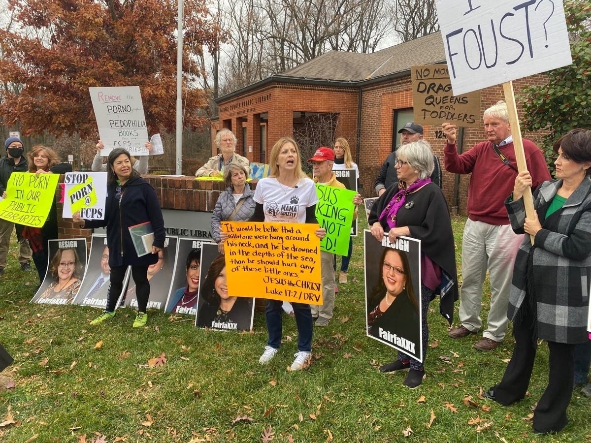 Stacy Langton spoke Thursday in opposition to the Fairfax County School Board's decision to follow CDC guidelines and continue to require masks for all people on school property. She's shown here (center in white shirt) in a Dec. 11, 2021 photo.
