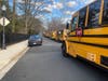 A line of buses extends out from the Knights of Columbus on Little Falls Road, where Yorktown High School students were being evacuated to on Thursday afternoon. The evacuation will delay the buses from serving other schools in the area.  