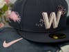 The Nationals' City Connect cherry blossom cap features a burst of flower petals and an architectural typeface "W" to represent the city's strength.