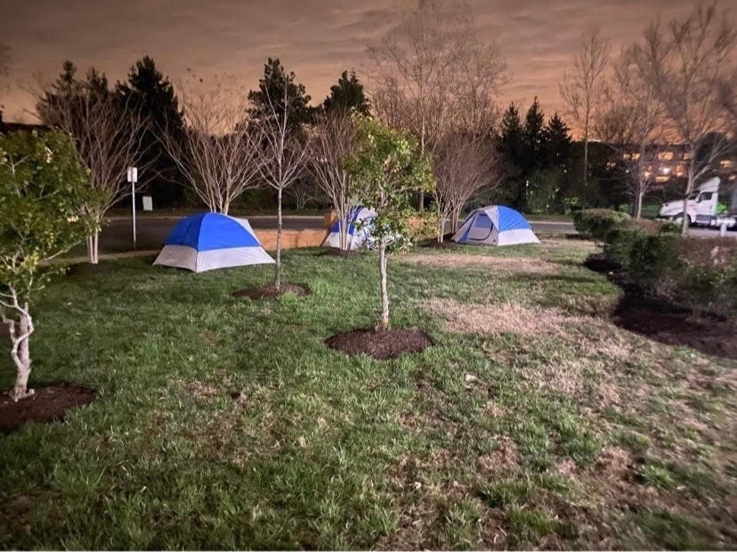 Reston Strong sets up tents outside the North County Governmental Center Monday night to advocate for temporary housing for the homeless.