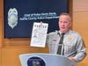 Fairfax County Police Chief Kevin Davis holds up a poster that helped in identifying William Clark, 59, as the suspect in a 1987 abduction and sexual assault of a 14-year-old girl.