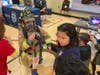 Firefighter/EMT Jordyn Goddard of Station 36 show Herndon Elementary students her gear.