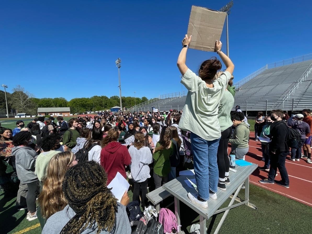 W.T. Woodson senior Ella Stamerra holds up a sign at the school's walkout as part of a Statewide Student Day of Action for Abortion Access organized by Generation Ratify Virginia.