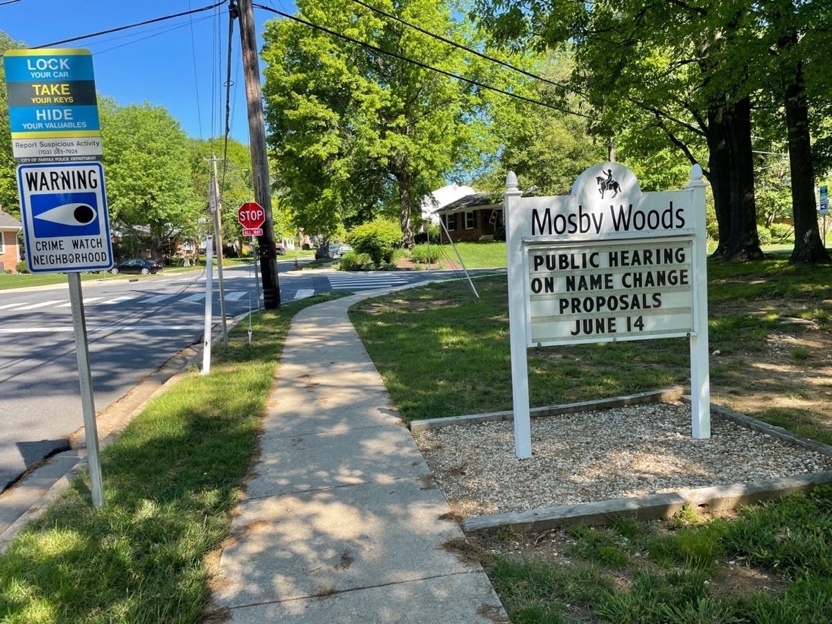 The Mosby Woods Community Association sign on Plantation Parkway in Fairfax City announces an upcoming public hearing on name change proposals for streets located in the neighborhood.