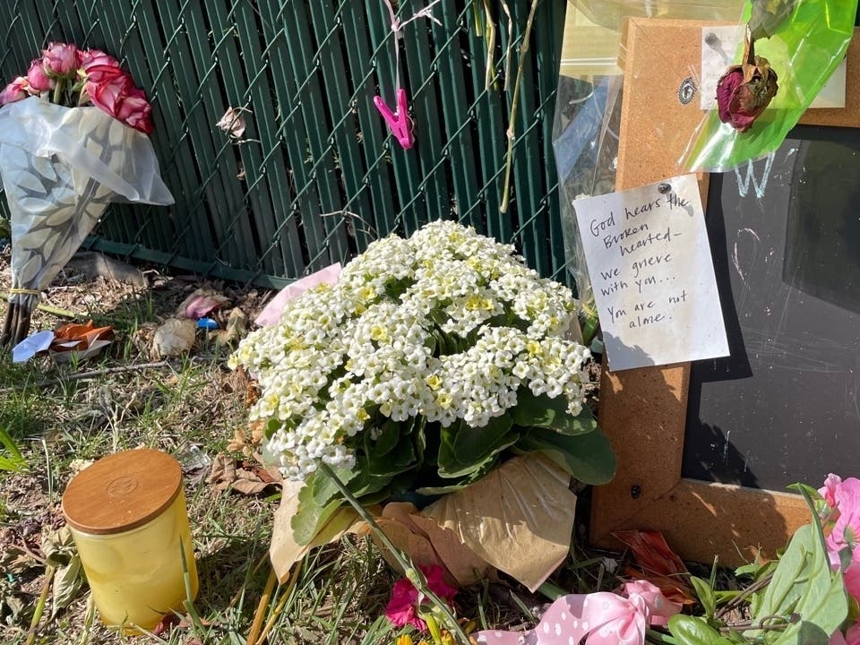 Mourners leave flowers, candles, handwritten messages and other items where two Oakton High School students were killed after being hit by a car near the Blake Lane/Five Oaks Road intersection in Fairfax on June 7.