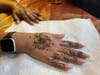 Indian artists were on hand Thursday night to draw traditional designs in henna