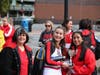 Herndon Town Councilmember Signe Friedrichs poses for a photo with members of the Class of 2025, whose float won the second place award in Saturday's Herndon High School Homecoming Parade.