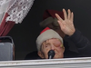 Vincent Gibbs, 86, is former Robert E. Peary High School English and drama teacher. He waves to students who came to serenade him Saturday with Christmas carols outside his Germantown home.