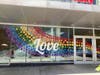 Image360 Fairfax installed an art display featuring a rainbow of flowers and empowering phrases at the atrium facing the Strawberry Lane public space.