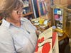 Sharon Buttram, owner of Lucy Loves, holds up a copy of the Wendy Ward Charm Book, which was for sale at the store located at 10414 Main St.