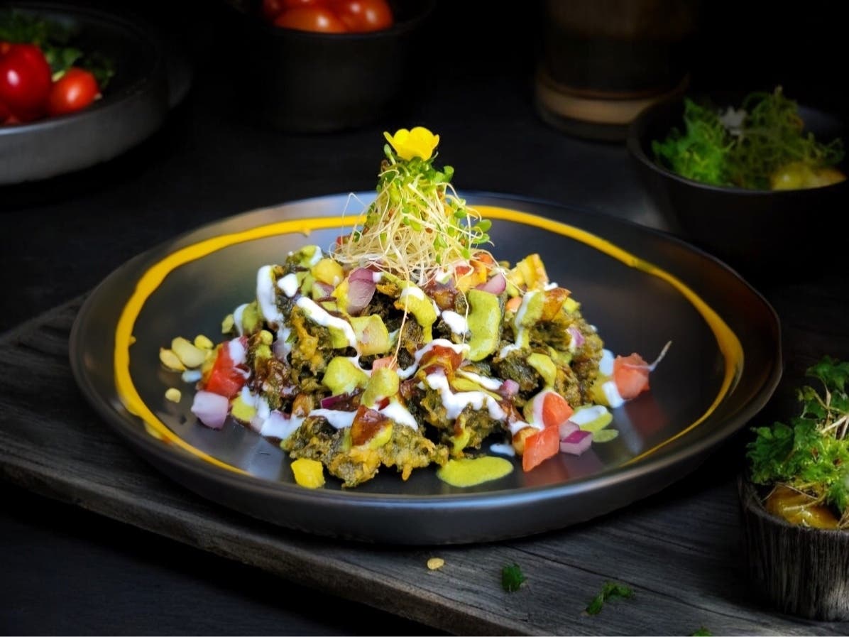 An example of Spice Kraft Indian Bistro's fusion twist is spinach pakora chaat, which the menu describes as "Crispy baby spinich fritters," with "bits of fresh tomato, onion, and pinapple all tossed in the flavor mixture of yogurt and tamarind sauce."