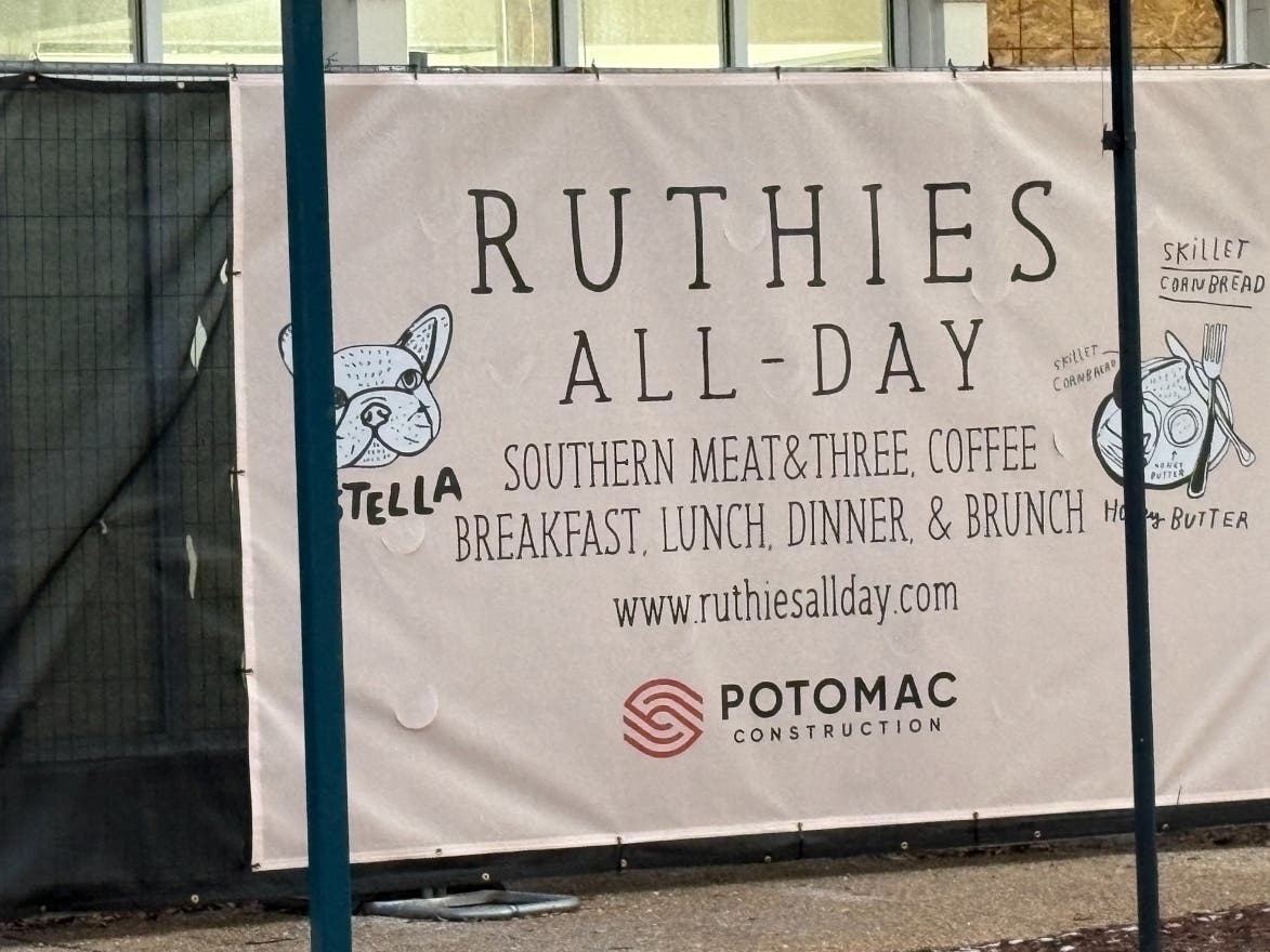 A sign hanging in the window at 11951 Grand Commons Ave. advertises the upcoming arrival of Ruthies All-Day.