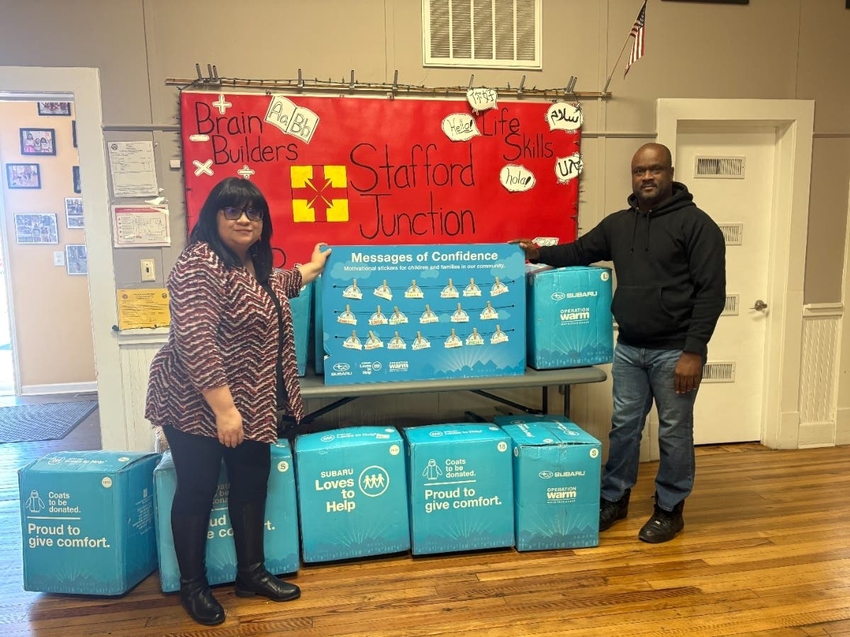 Representatives from Sheehy Subaru of Fredericksburg and Stafford Junction stand alongside winter coats delivered to children in need as part of the Subaru Loves to Help initiative in partnership with Operation Warm.