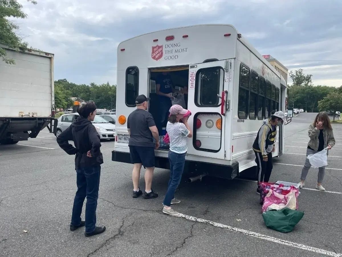 In Fairfax City, FACETS volunteers provide hot meals every afternoon out of the back of a van in the Home Depot parking lot.