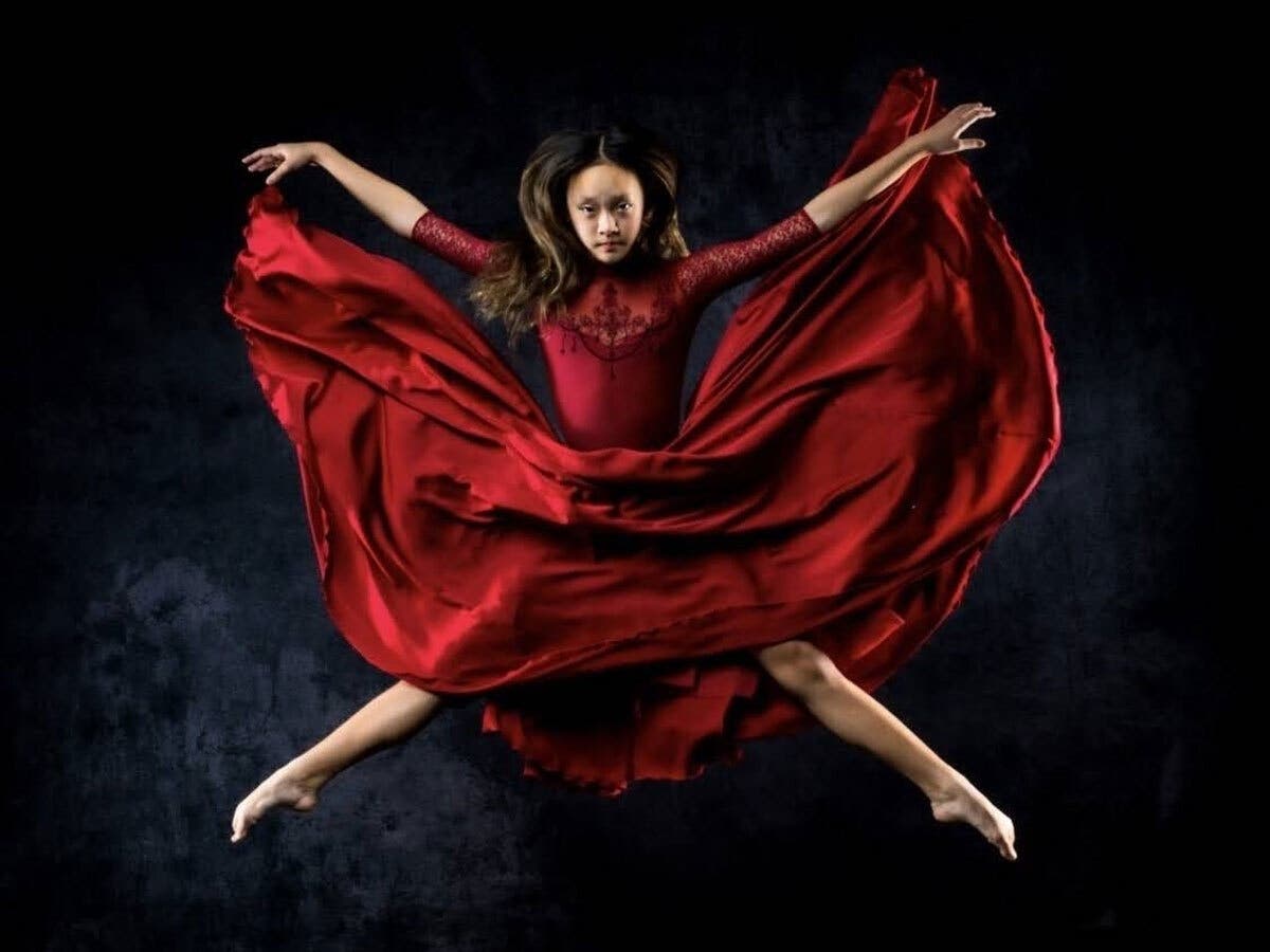 Lucy Park of Artists in Motion/Alchemy Ballet, a Herndon-based nonprofit, dances in a red dress.