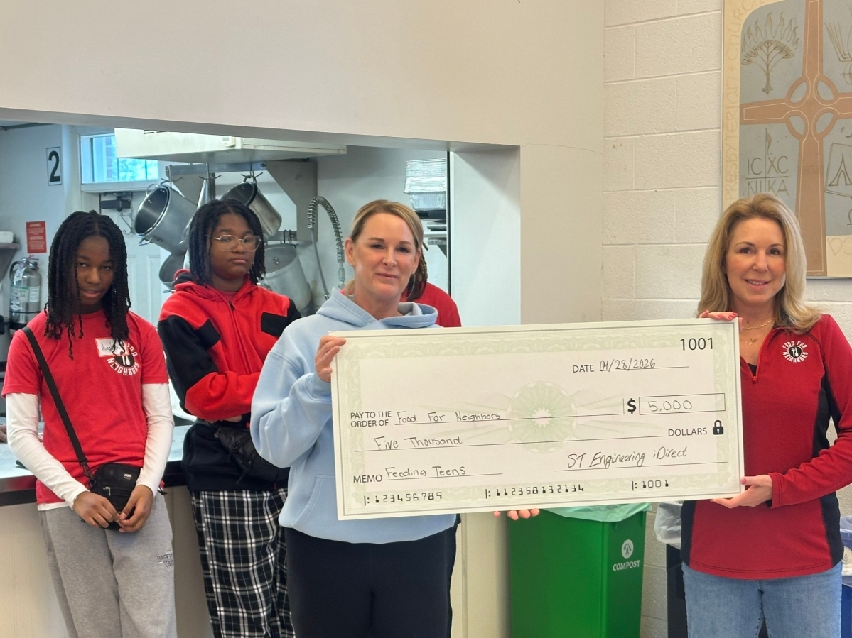 ST Engineering iDirect presented Food For Neighbors with a $5,000 check. Julie Bettinger, Chief Marketing Officer presented the check to Karen Joseph, founder and executive director of Food Food Neighbors.