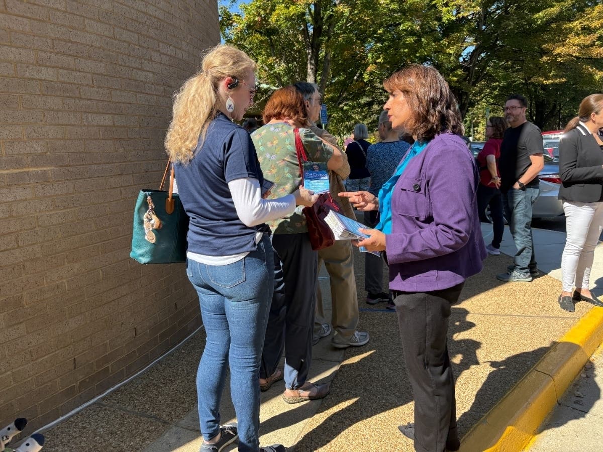 The Fairfax County Democratic Committee used ranked choice voting in its Oct. 4, 2025 fire house primary. Here, candidate Rachna Sizemore-Heizer (right) talks to a voter outside the polls at the Kings Park Library.