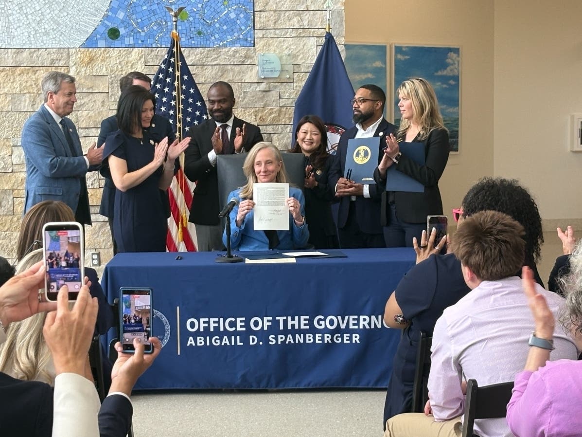 Gov. Abigail Spanberger (D) signs health care bills at Inova Schar Cancer Institute in Fairfax on May 13, capping insulin costs and expanding coverage for Virginia patients.