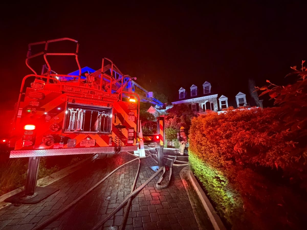 Fairfax County fire and rescue crews pulled a resident and dog from a burning McLean home after flames spread from the garage overnight.