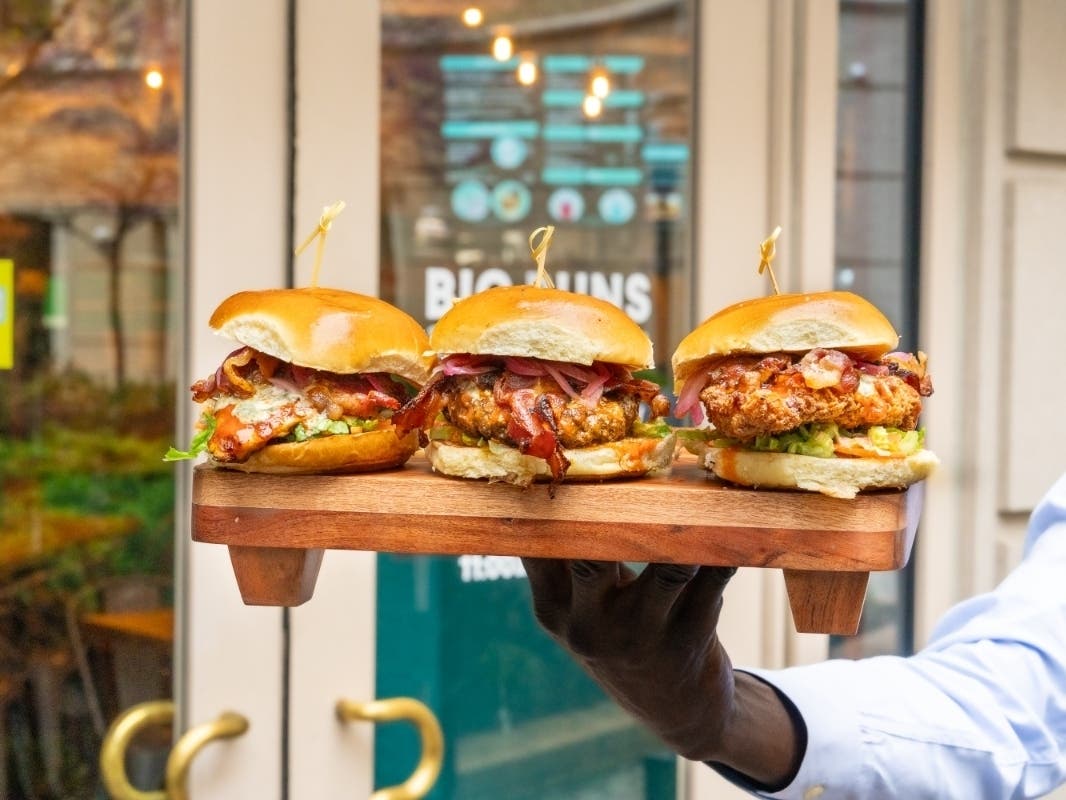 The Burger of the Month is the Buffalo Wing Burge, topped with blue cheese crumbles, Applewood spoked bacon, sauteed onions, Frank’s Tangy buffalo aioli, dressed carrots, celery and lettuce mix.