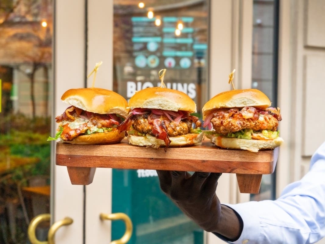 The Burger of the Month is the Buffalo Wing Burge, topped with blue cheese crumbles, Applewood spoked bacon, sauteed onions, Frank’s Tangy buffalo aioli, dressed carrots, celery and lettuce mix.