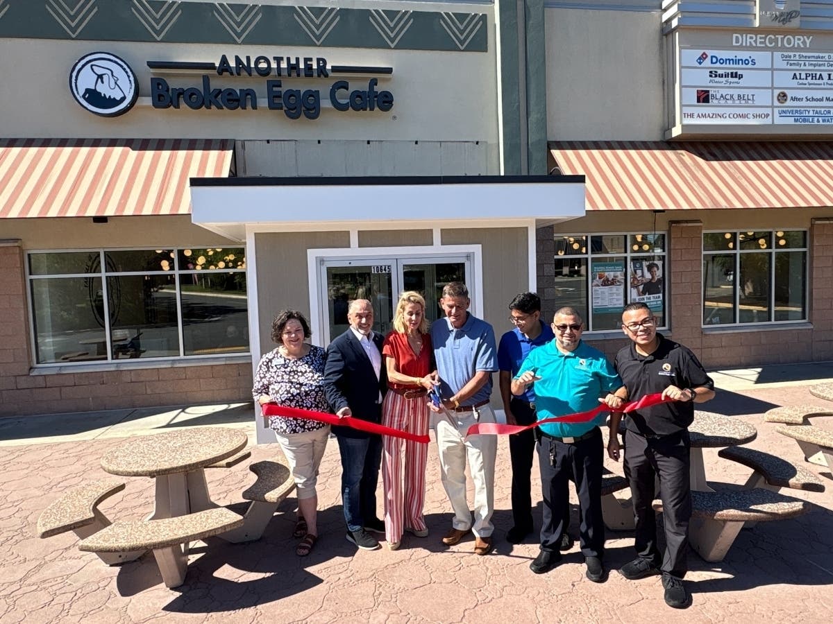 Franchisees Demetrios and Megan Florakis of EOS Ventures Inc. and Jorge Salvat, president and CEO of Another Broken Egg Cafe, celebrate the opening of their new cafe at University Mall in Fairfax.