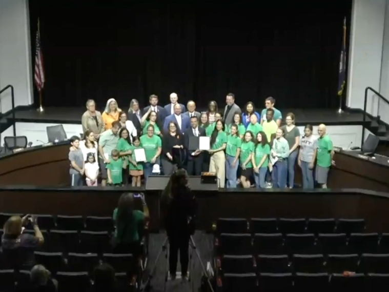 Fairfax County School Board and audience members pose for a photo Thursday night after the board passed a resolution establishing guiding principles for the future use of instructional technology and artificial intelligence in FCPS classrooms.