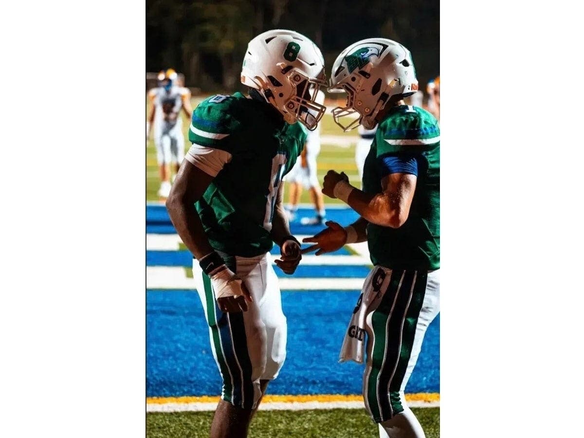 Running back James Smith and quarterback Christian Wyatt discuss one of Smith's two touchdown runs in South Lakes' 30-7 victory over Robinson Thursday night at South Lakes. Smith rushed for 124 yards; Wyatt for 126.