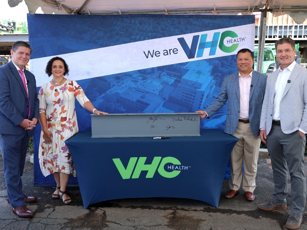 From left, Chris Lane, president & CEO of VHC Health; Supervisor Dalia Palchik (D-Providence); John Nguyen, chairman, Board of Directors, VHC Health and Thom Herrmann, CEO, Intuitive Health pose for a photo during the Aug. 24 beam-signing ceremony.