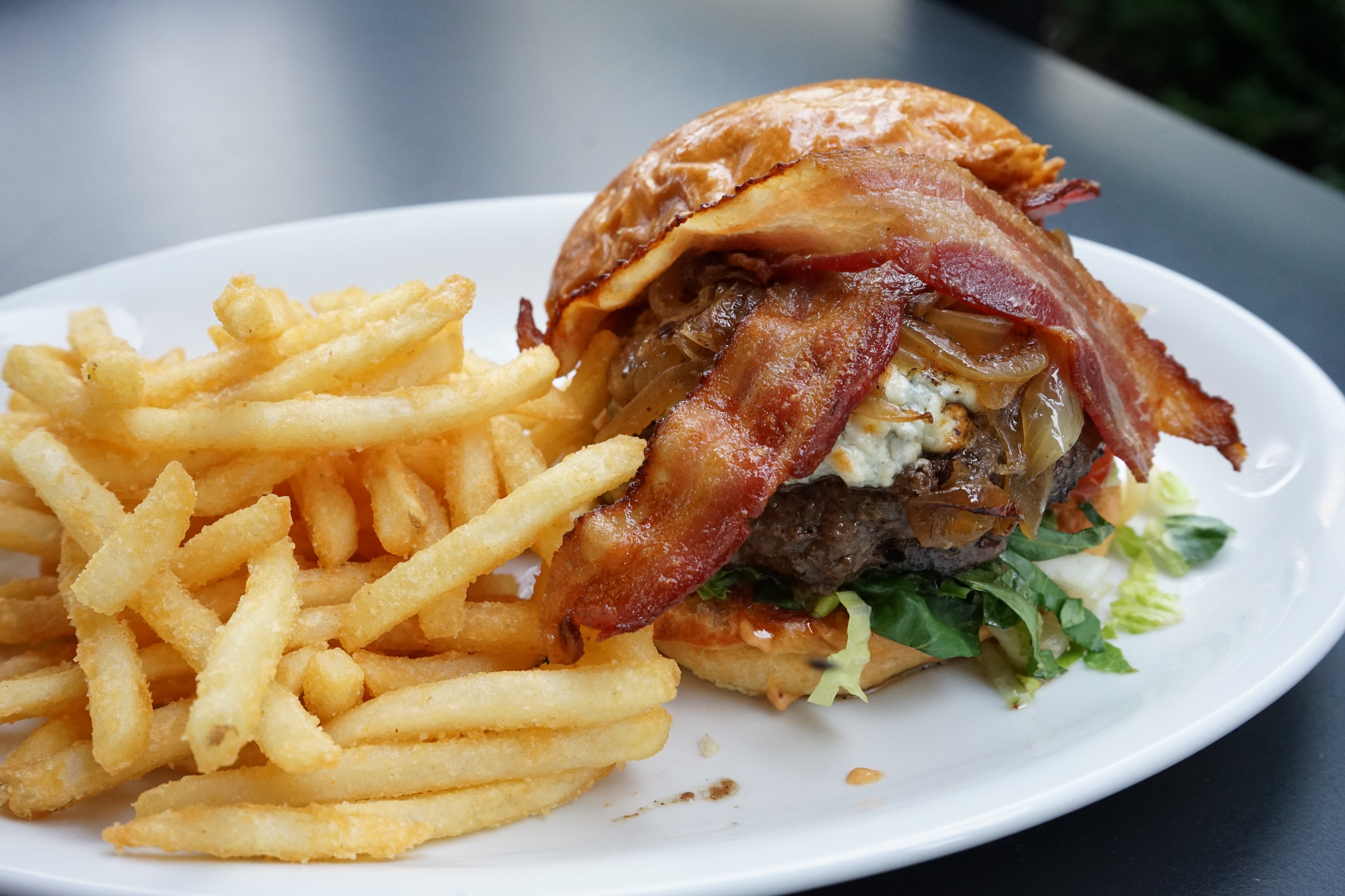 The menu includes hand-smashed burgers, house-smoked wings, hand-cut fries, shareable platters and seasonal specials. (MHZ)